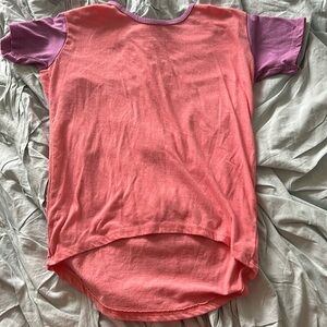 Lularoe girls’ t-shirt. Size 6. Salmon color with purple sleeves.